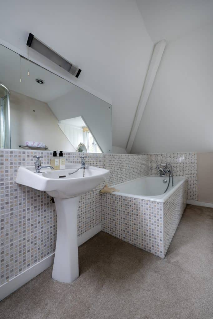 a room with a sink and a mirror