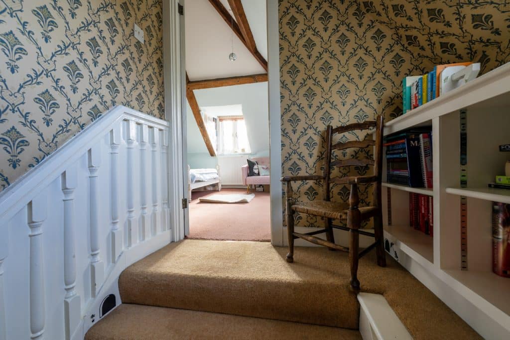 a bedroom with a bed and a mirror in a room