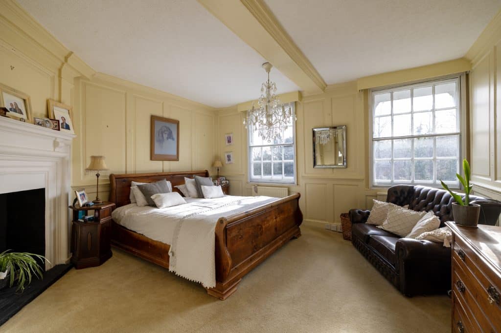 a bedroom with a large bed in a room