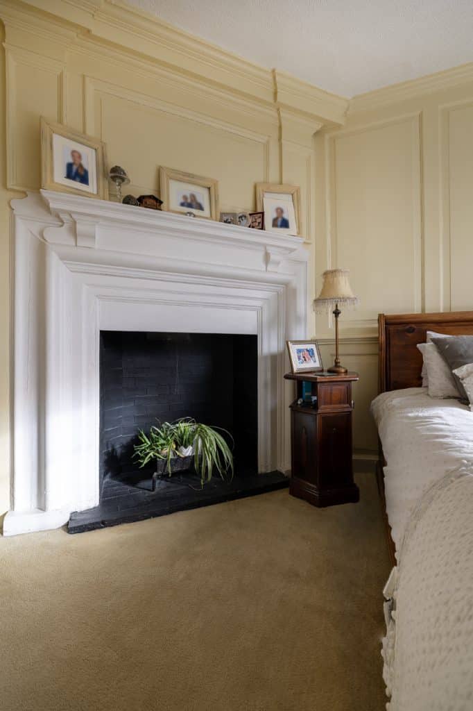 a living room with a bed and a fireplace