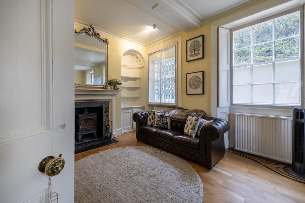 a living room with a fireplace and a large window