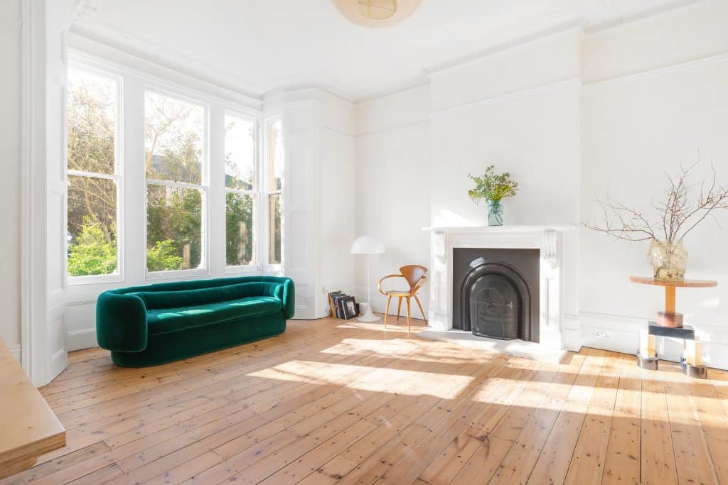 a living room with a fireplace and a large window