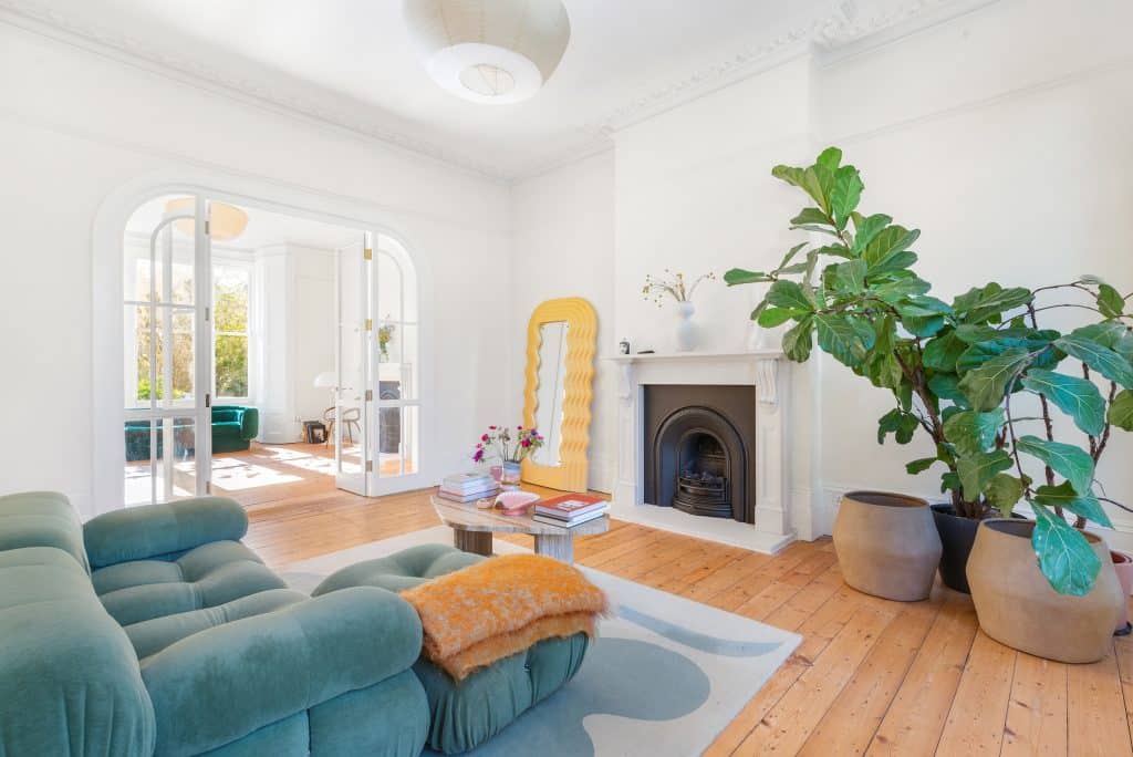 a living room filled with furniture and vase of flowers on a table