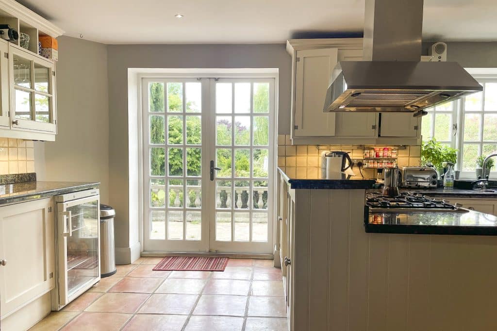 PARK LODGE1. Kitchen-terracota-floor-cooker-worktops-glass-doors-garden-TV-filming-location-hire-lodge-London