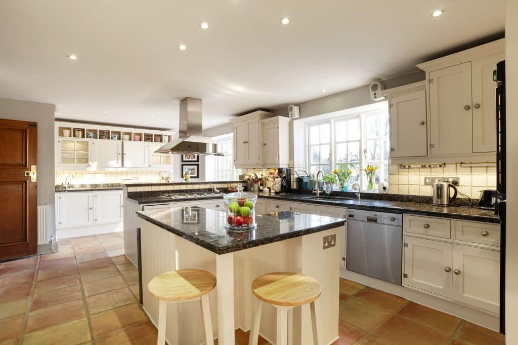 a kitchen with an island in the middle of a room