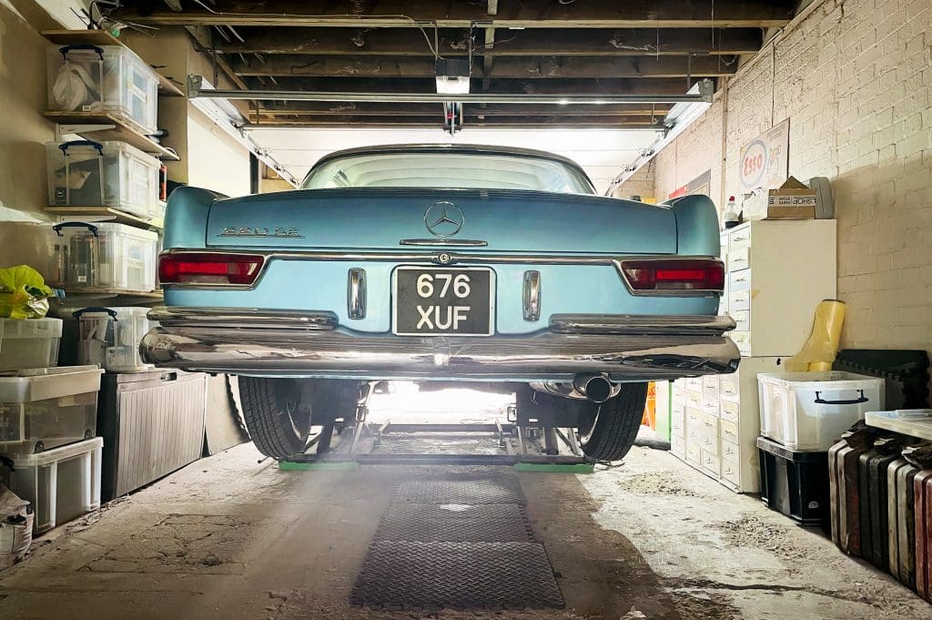 PARK LODGE6. Garage-mercedes-rear-car-repair-car-lift-petrol-cans-TV-filming-location-hire-lodge-London