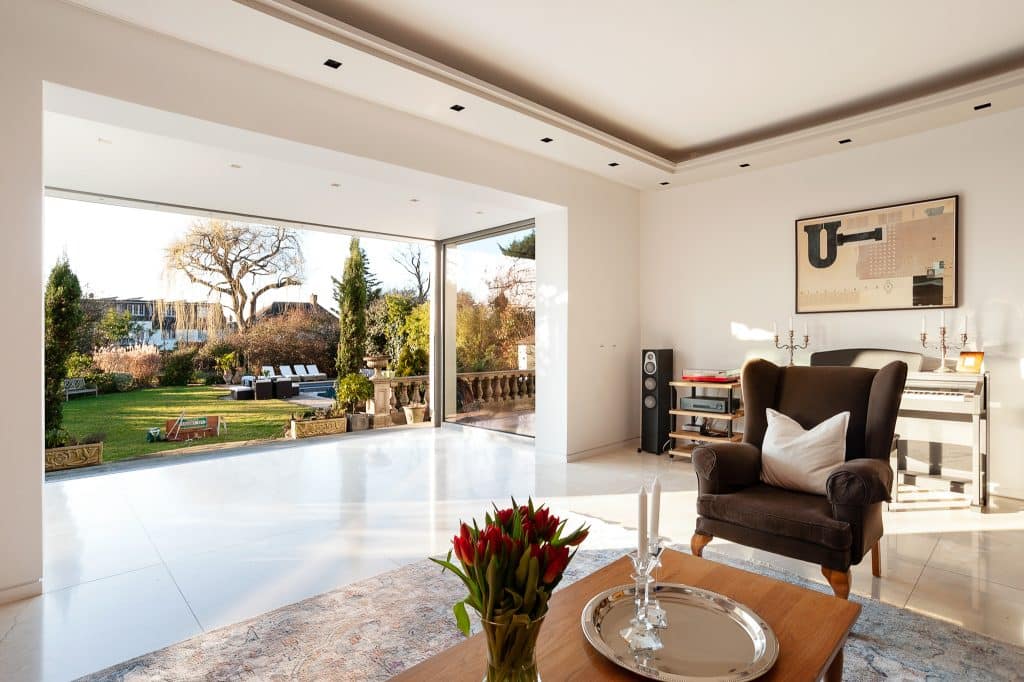 a living room filled with furniture and vase of flowers on a table
