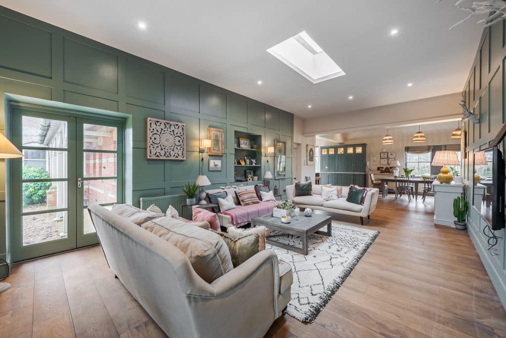 a living room filled with furniture and a large window