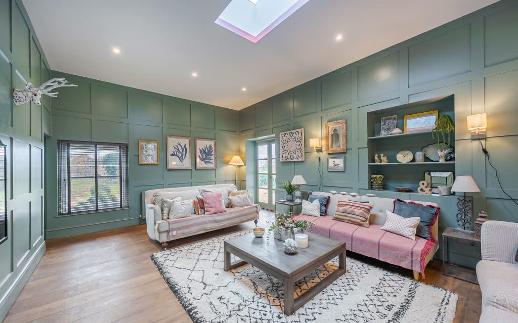 a living room filled with furniture and a large window