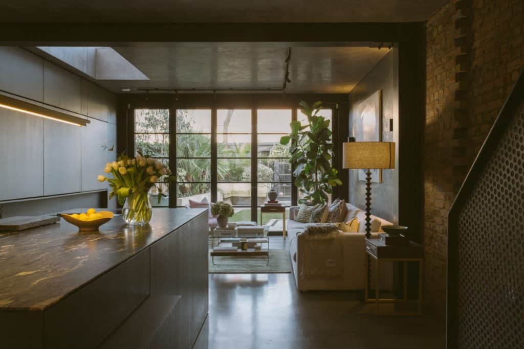 a room filled with furniture and vase of flowers on a table