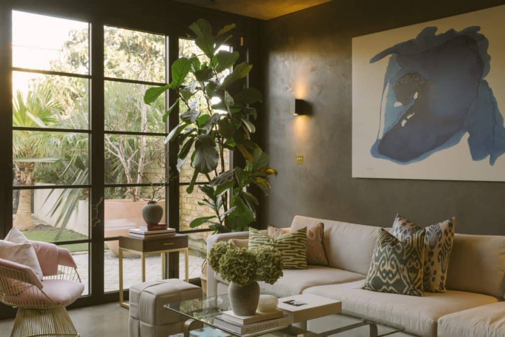 a living room filled with furniture and a large window