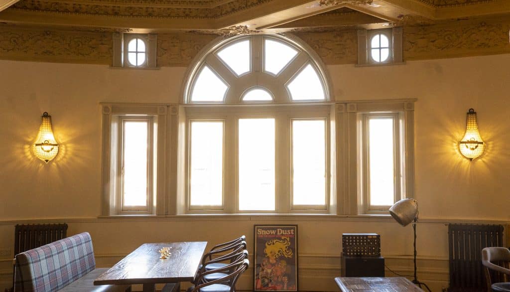 a living room filled with furniture and a large window