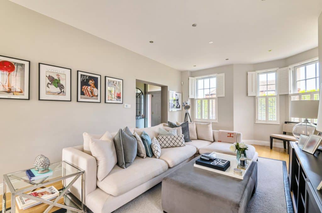 a living room filled with furniture and a large window