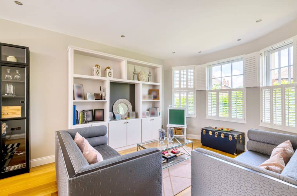 a living room filled with furniture and a large window