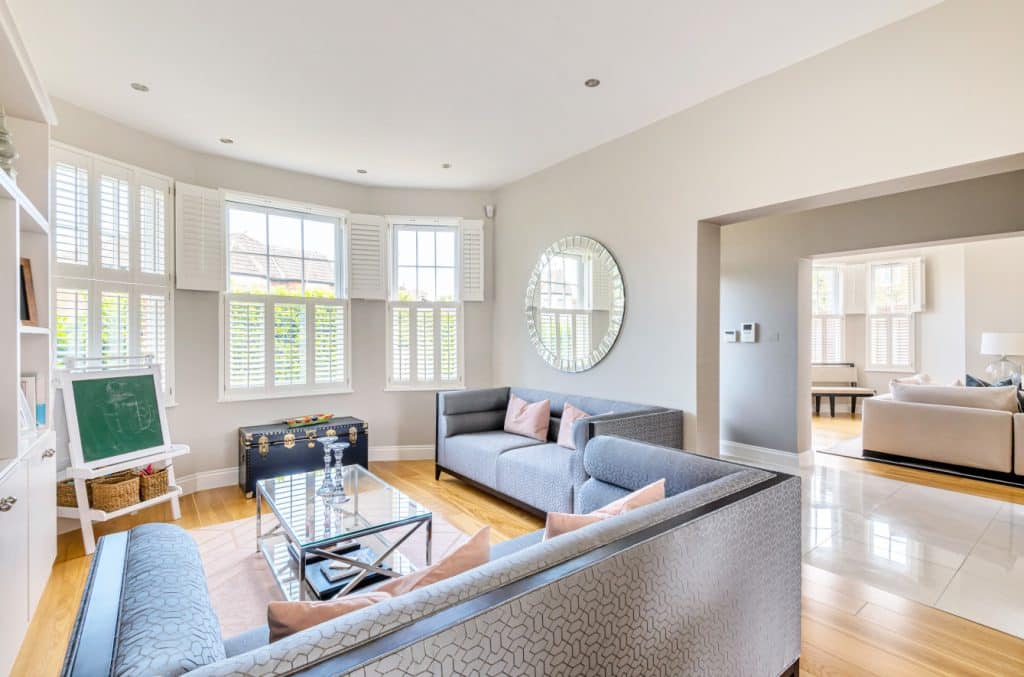 a living room filled with furniture and a large window