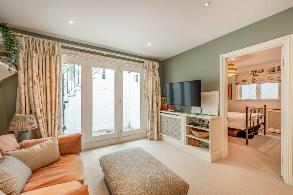 a living room filled with furniture and a large window