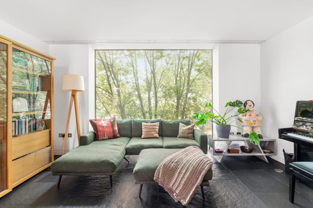 a living room filled with furniture and a large window