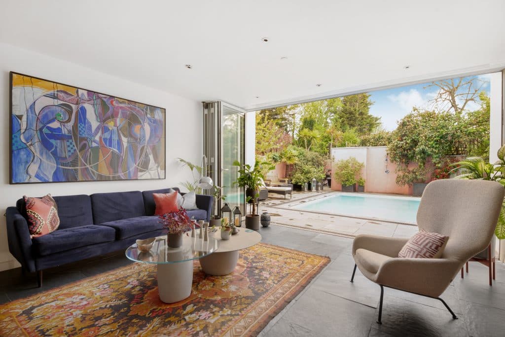 a living room filled with furniture and a large window
