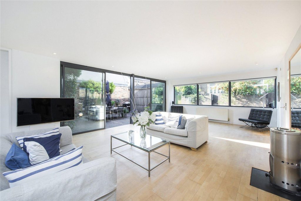 a living room filled with furniture and a large window
