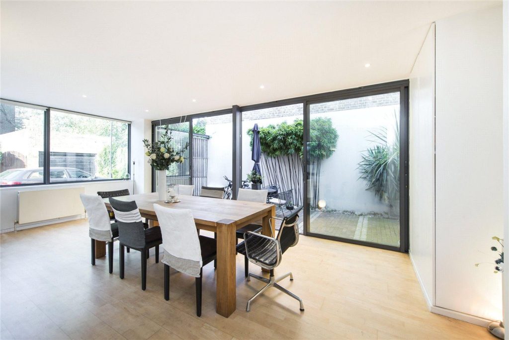 a living room filled with furniture and a large window