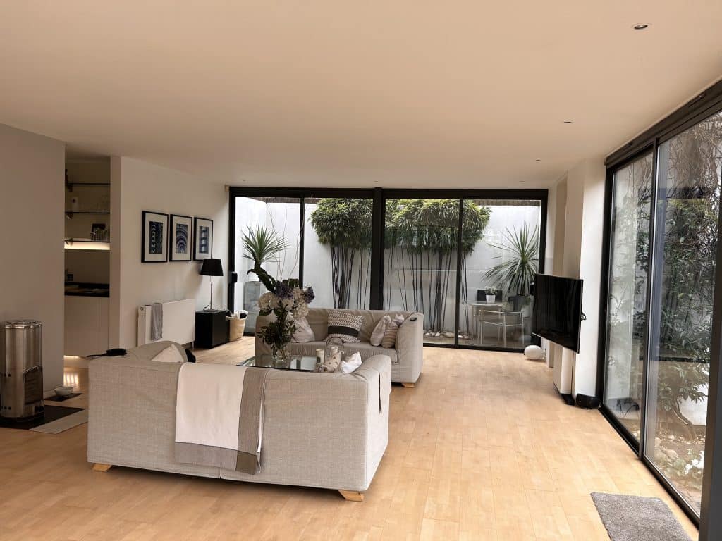 a living room filled with furniture and a large window