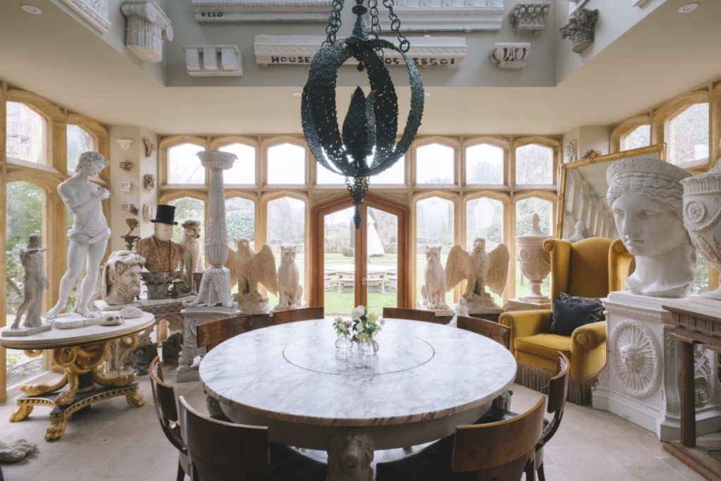 a room filled with furniture and vase of flowers on a table