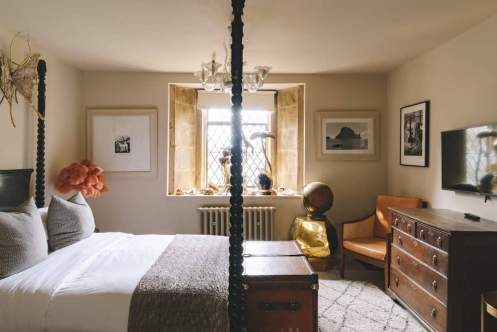 a bedroom with a bed and a chair in a room