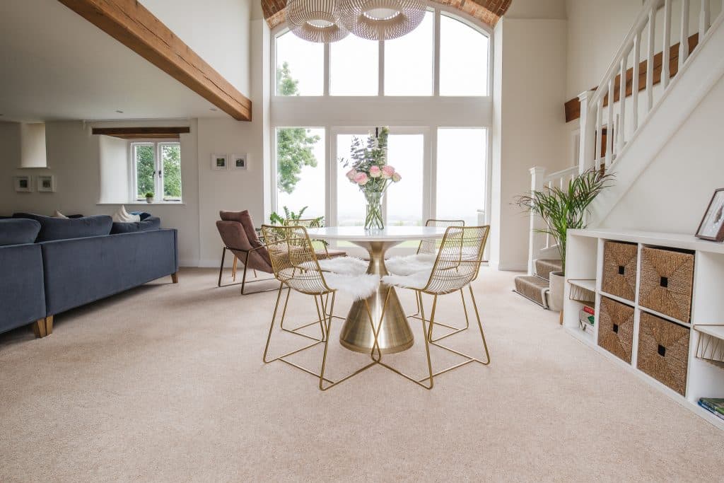 a living room filled with furniture and a large window