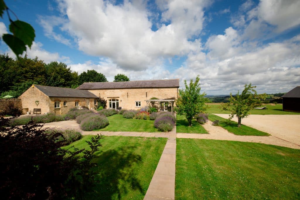 a path with grass in front of a house