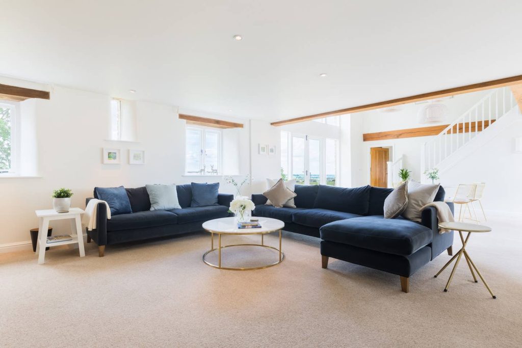 a living room filled with furniture and a large window
