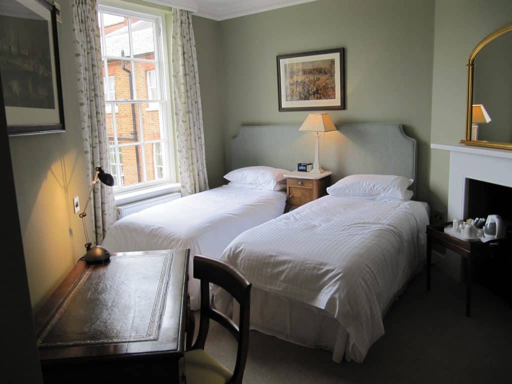 a bedroom with a bed and desk in a room