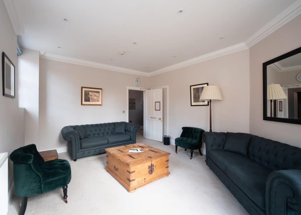 a living room filled with furniture and a flat screen tv