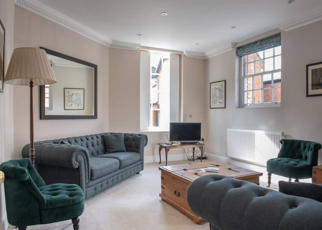 a living room filled with furniture and a flat screen tv