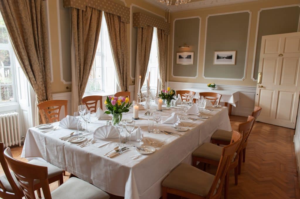 a dining room table in front of a window