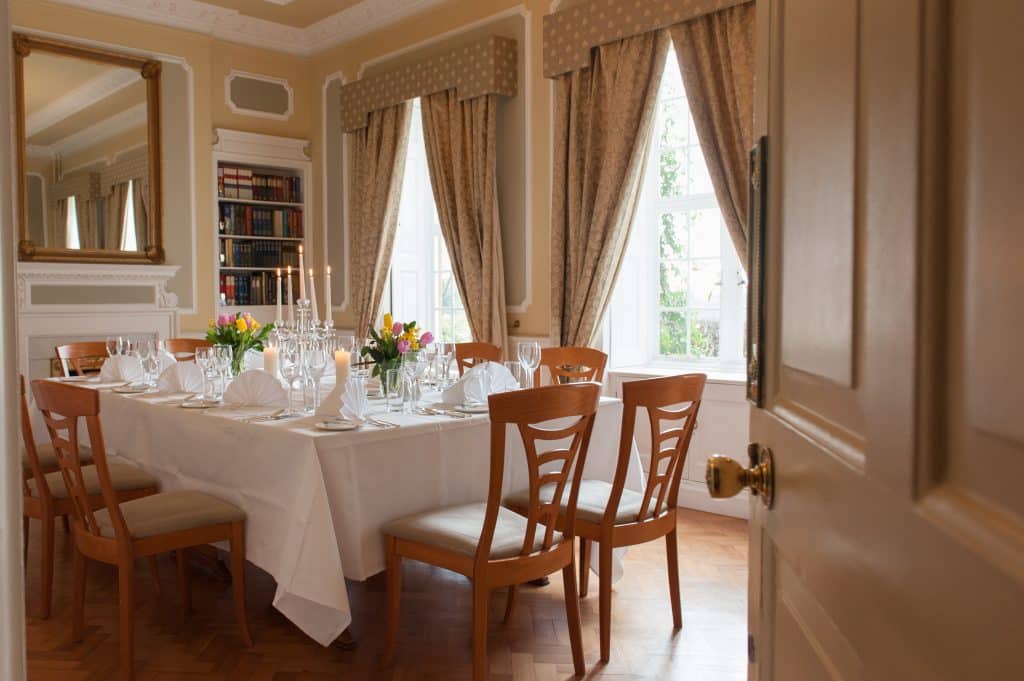 a dining room table in front of a window