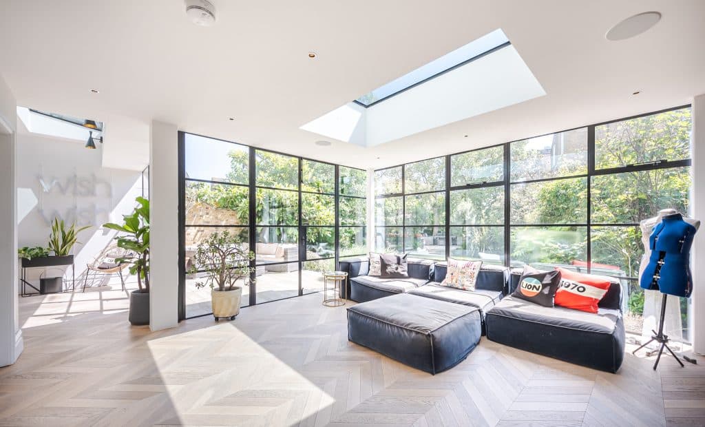 a living room filled with furniture and a large window
