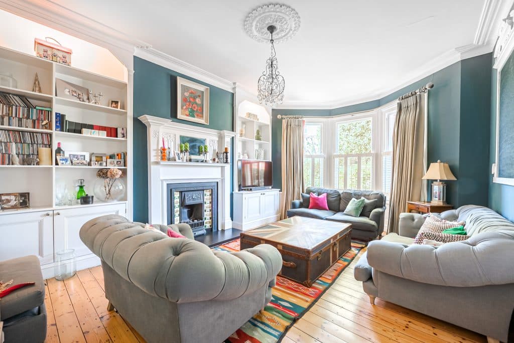 a living room filled with furniture and a large window