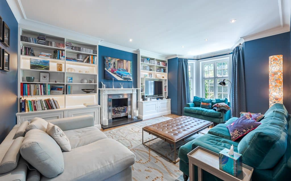 a living room filled with furniture and a book shelf