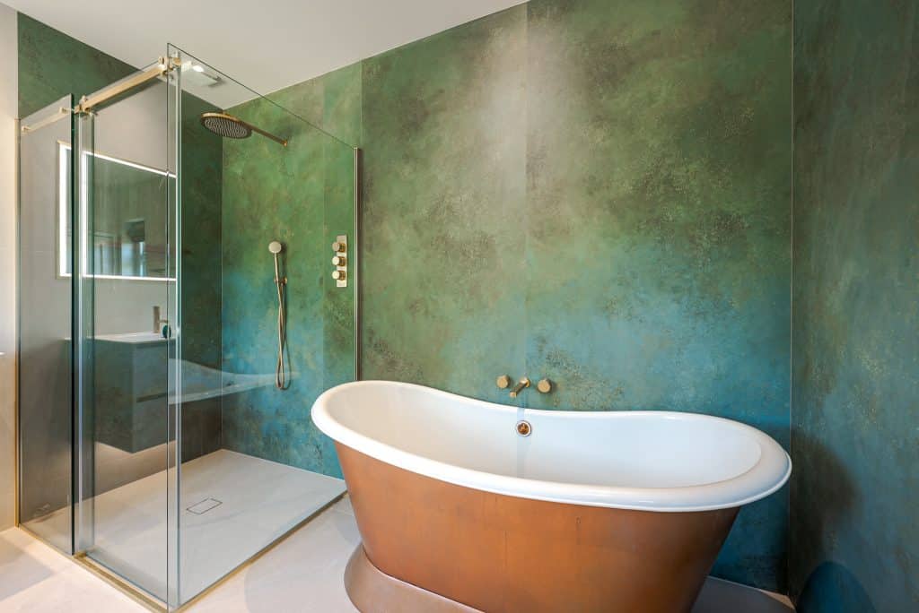 a large tub next to a glass shower door
