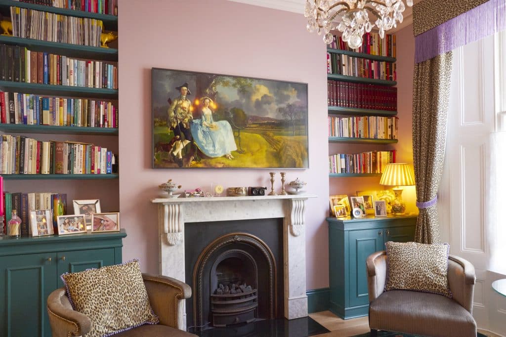a living room filled with furniture and a book shelf