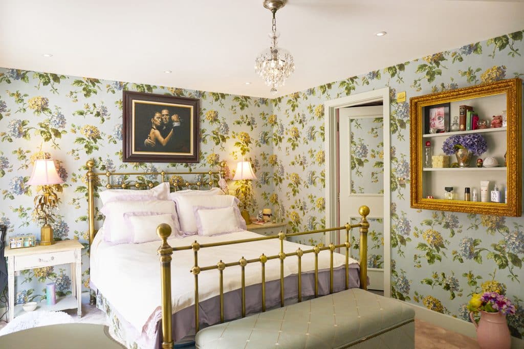 a bedroom with a bed and a mirror