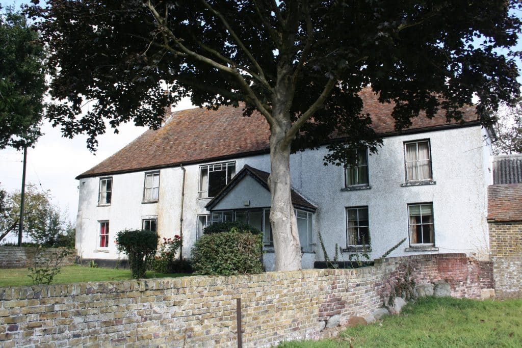 a tree in front of a house