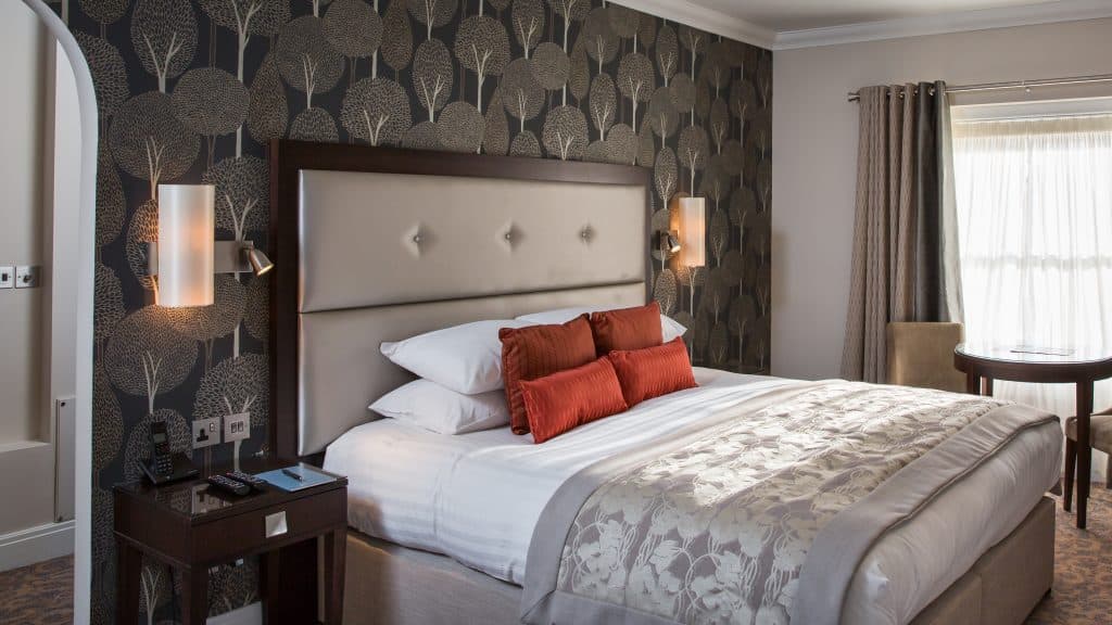a bedroom with a large bed in a hotel room