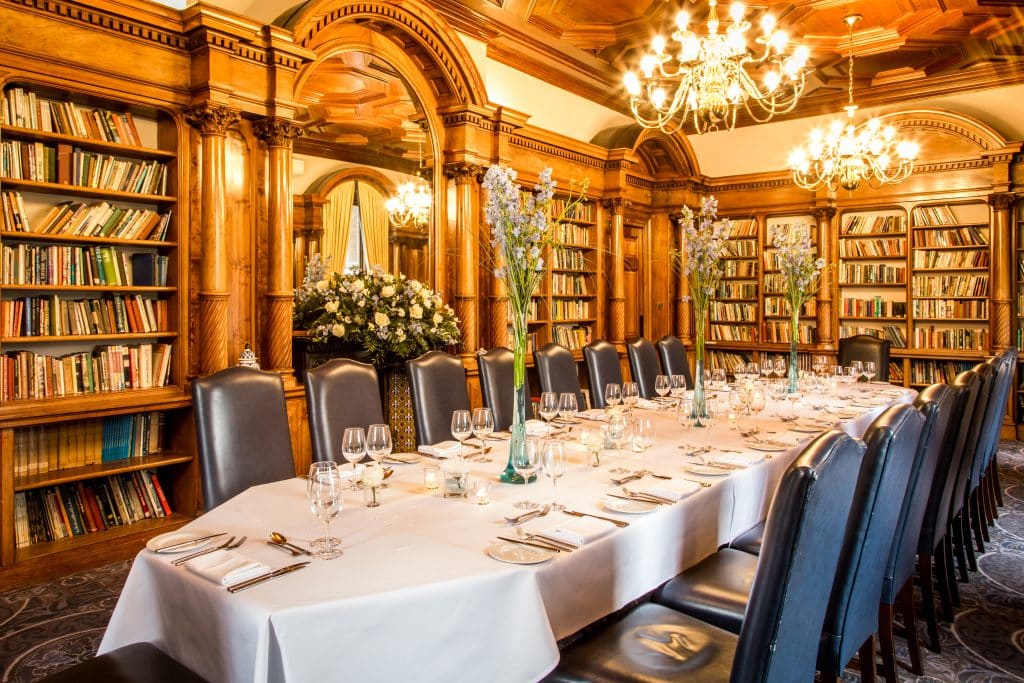 a dining room table and chairs in a library
