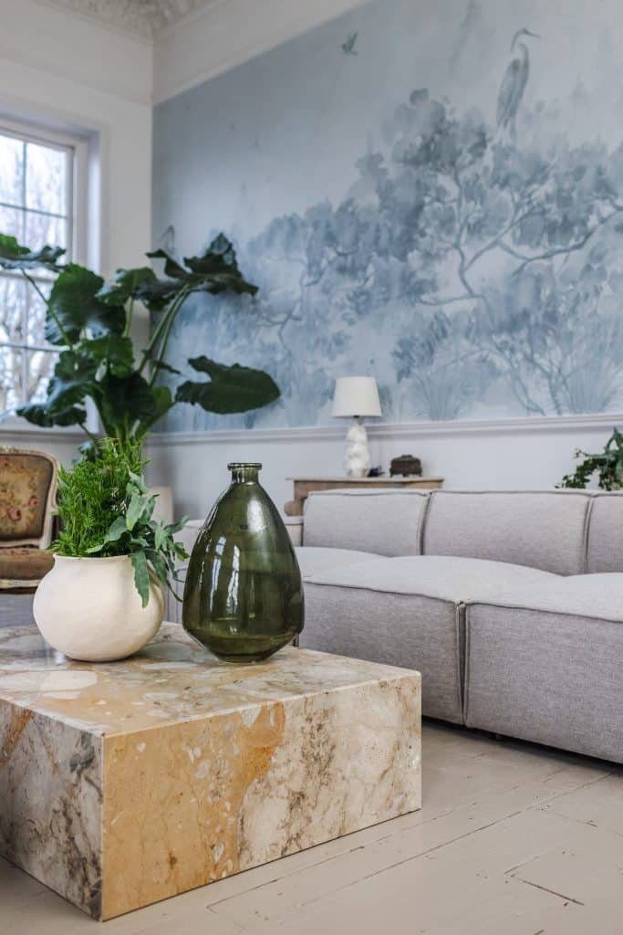 a vase of flowers on a table next to a fireplace