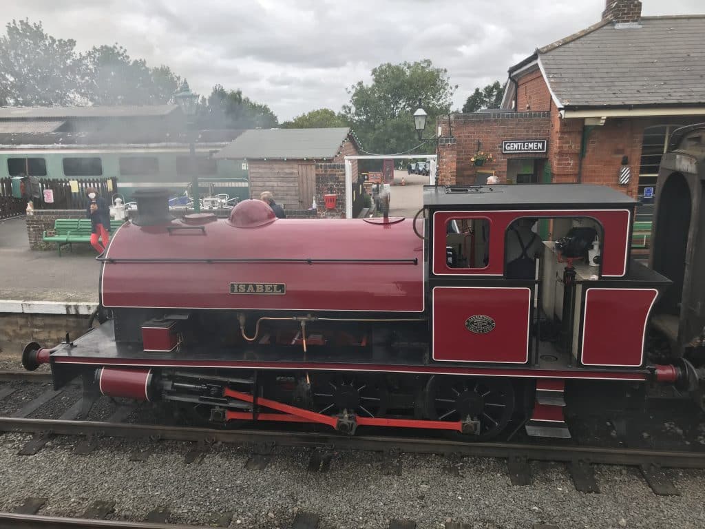 a train is parked on the side of a building