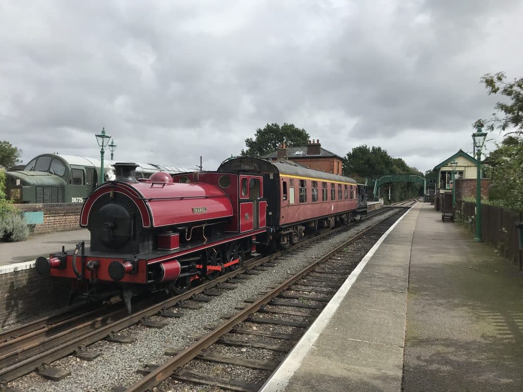 a train engine carrying carts down a track