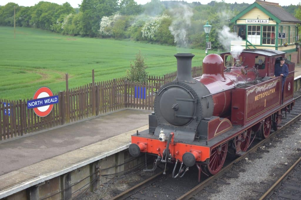 a steam engine is sitting on a train track