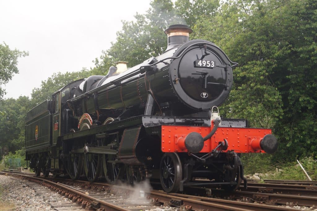 a train engine carrying carts down a track