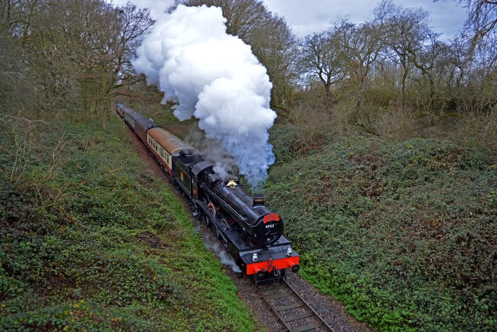 a train on a track with smoke coming out of it